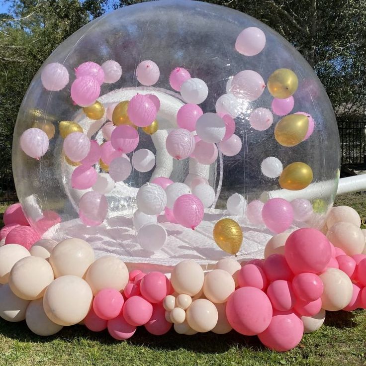 Close-up of vibrant balloons floating inside the bubble house